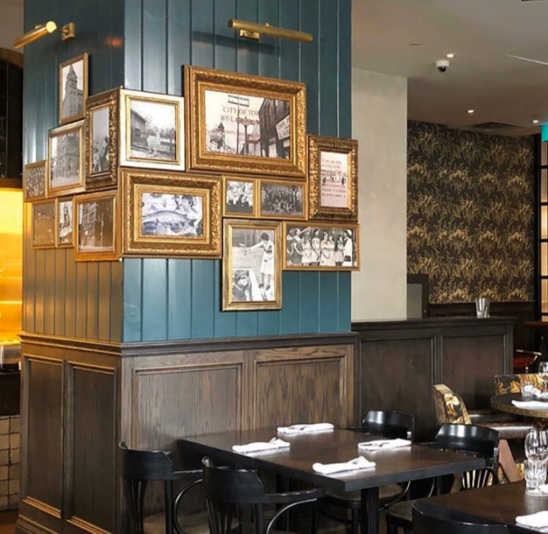 Gold frames around a column in a restaurant